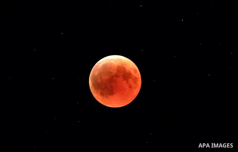 This picture shows the moon during the total lunar eclipse in the sky of the West Bank city of Hebron on July 27, 2018. The longest "blood moon" eclipse this century began on July 27, coinciding with Mars' closest approa...