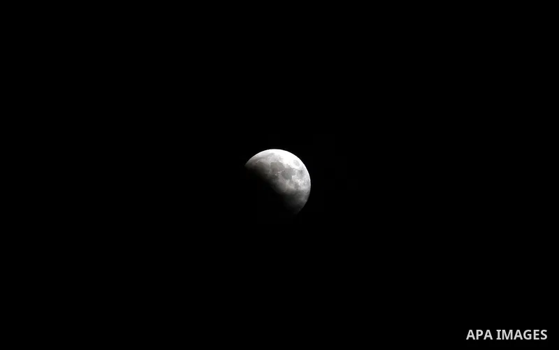 This picture shows the moon during the total lunar eclipse in the sky of Gaza City on July 27, 2018. The longest "blood moon" eclipse this century began on July 27, coinciding with Mars' closest approach in 15 years to t...