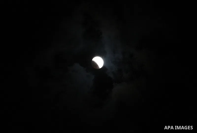 This picture shows the moon during the total lunar eclipse in the sky of Gaza City on July 27, 2018. The longest "blood moon" eclipse this century began on July 27, coinciding with Mars' closest approach in 15 years to t...