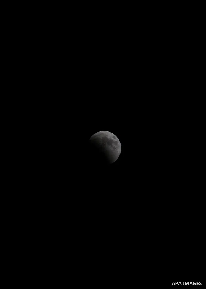 This picture shows the moon during the total lunar eclipse in the sky of Gaza City on July 27, 2018. The longest "blood moon" eclipse this century began on July 27, coinciding with Mars' closest approach in 15 years to t...