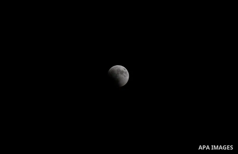 This picture shows the moon during the total lunar eclipse in the sky of Gaza City on July 27, 2018. The longest "blood moon" eclipse this century began on July 27, coinciding with Mars' closest approach in 15 years to t...