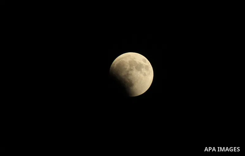 This picture shows the moon during the total lunar eclipse in the sky of Gaza City on July 27, 2018. The longest "blood moon" eclipse this century began on July 27, coinciding with Mars' closest approach in 15 years to t...