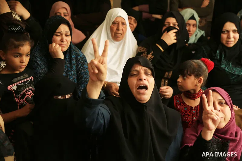 Relatives of Palestinian Mohmen al-Hams, 17, who died of wounds after being shot by Israeli troops during clashes along the border the previous day mourn during his funeral in the Rafah refugee camp in the southern Gaza...