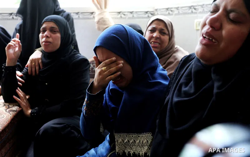 Relatives of Palestinian Mohmen al-Hams, 17, who died of wounds after being shot by Israeli troops during clashes along the border the previous day mourn during his funeral in the Rafah refugee camp in the southern Gaza...
