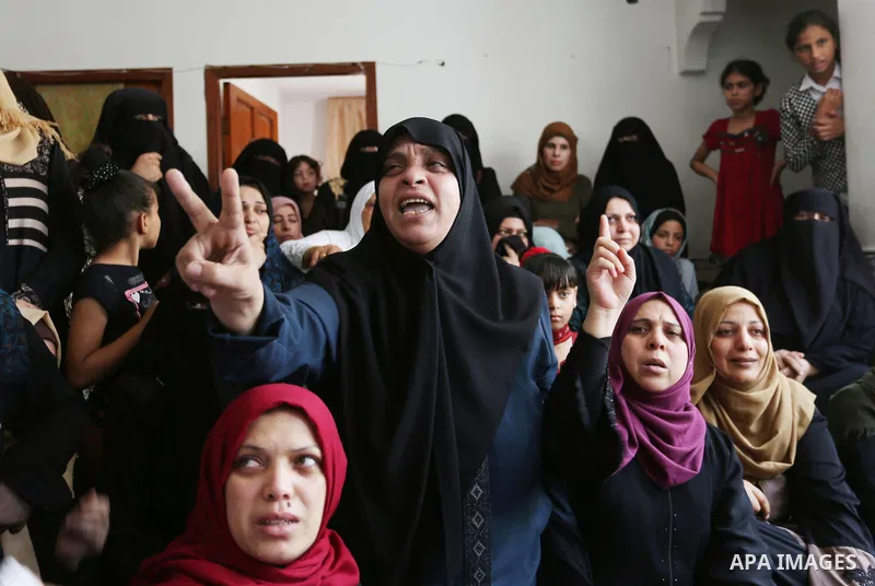 Relatives of Palestinian Mohmen al-Hams, 17, who died of wounds after being shot by Israeli troops during clashes along the border the previous day mourn during his funeral in the Rafah refugee camp in the southern Gaza...