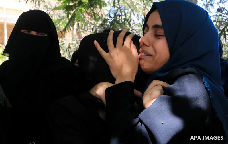 Relatives of Palestinian Ghazi Abu Mustafa, 43, who was shot dead by Israeli troops during clashes along the border the previous day, mourn during his funeral in Khan Younis in the southern Gaza Strip on July 28, 2018. P...