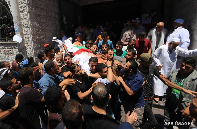 Mourners carry the body of Palestinian Ghazi Abu Mustafa, 43, who was shot dead by Israeli troops during clashes along the border the previous day, carry his body during his funeral in Khan Younis in the southern Gaza St...