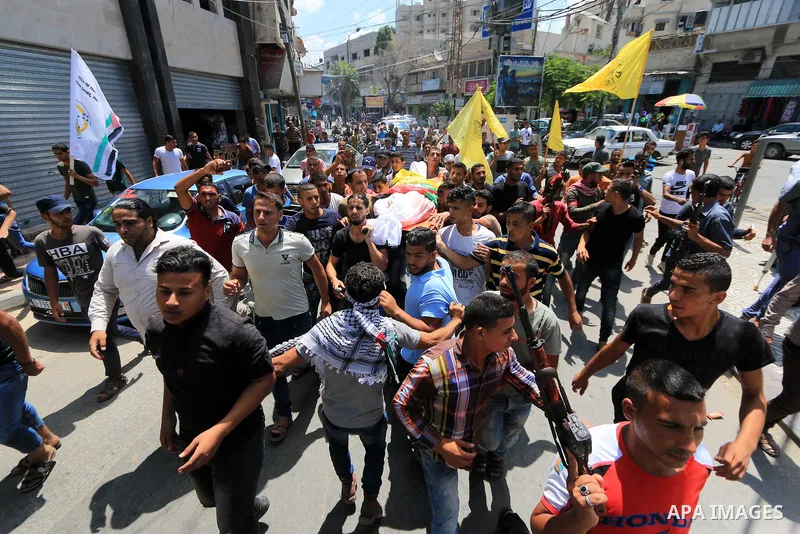 Mourners carry the body of Palestinian Ghazi Abu Mustafa, 43, who was shot dead by Israeli troops during clashes along the border the previous day, carry his body during his funeral in Khan Younis in the southern Gaza St...