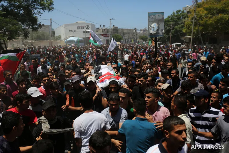 Mourners carry the bodies of Mohmen al-Hams, 17, and Majdi al-Sutari, 11, who were shot dead by Israeli troops during clashes along the border the previous day, during their funeral in Rafah in the southern Gaza Strip on...