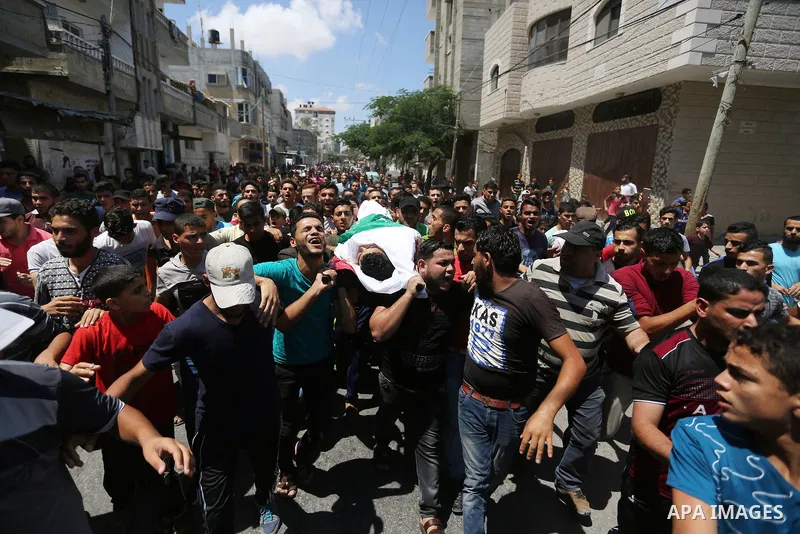 Relatives of Palestinian Mohmen al-Hams, 17, who died of wounds after being shot by Israeli troops during clashes along the border the previous day carry his body during his funeral in the Rafah refugee camp in the south...