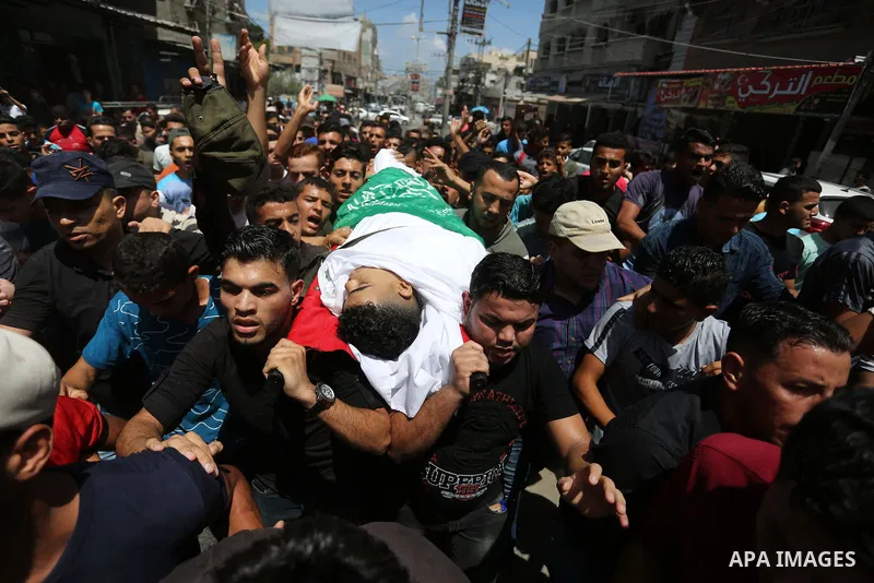 Relatives of Palestinian Mohmen al-Hams, 17, who died of wounds after being shot by Israeli troops during clashes along the border the previous day carry his body during his funeral in the Rafah refugee camp in the south...