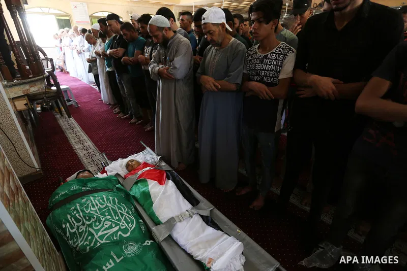 Mourners pray over the bodies of Mohmen al-Hams, 17, and Majdi al-Sutari, 11, who were shot dead by Israeli troops during clashes along the border the previous day, at a mosque during their funeral in Rafah in the southe...
