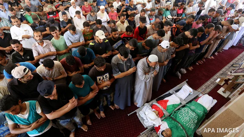 Mourners pray over the bodies of Mohmen al-Hams, 17, and Majdi al-Sutari, 11, who were shot dead by Israeli troops during clashes along the border the previous day, at a mosque during their funeral in Rafah in the southe...