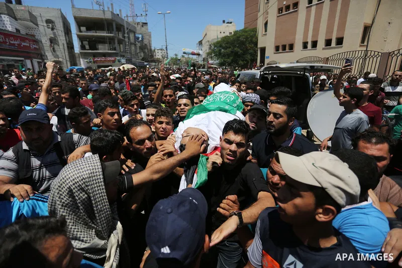 Mourners carry the bodies of Mohmen al-Hams, 17, and Majdi al-Sutari, 11, who were shot dead by Israeli troops during clashes along the border the previous day, during their funeral in Rafah in the southern Gaza Strip on...