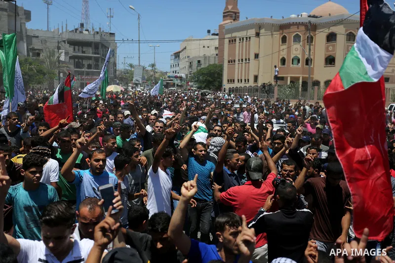 Mourners carry the bodies of Mohmen al-Hams, 17, and Majdi al-Sutari, 11, who were shot dead by Israeli troops during clashes along the border the previous day, during their funeral in Rafah in the southern Gaza Strip on...