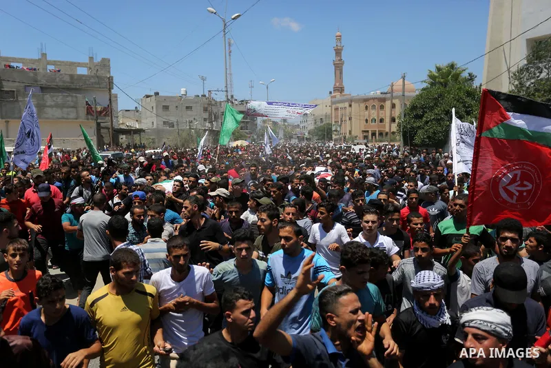 Mourners carry the bodies of Mohmen al-Hams, 17, and Majdi al-Sutari, 11, who were shot dead by Israeli troops during clashes along the border the previous day, during their funeral in Rafah in the southern Gaza Strip on...