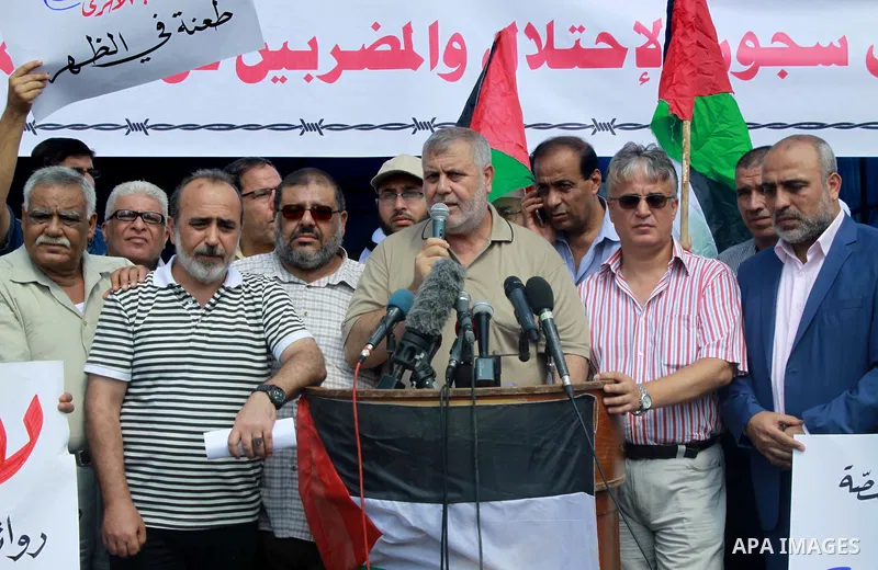 Palestinians take part in a protest to show solidarity with Palestinian prisoners are paid their salaries in Iseali jails in front of the Council of Ministers headcuarter in Gaza City, on July 29, 2018. Photo by Bashar Z...