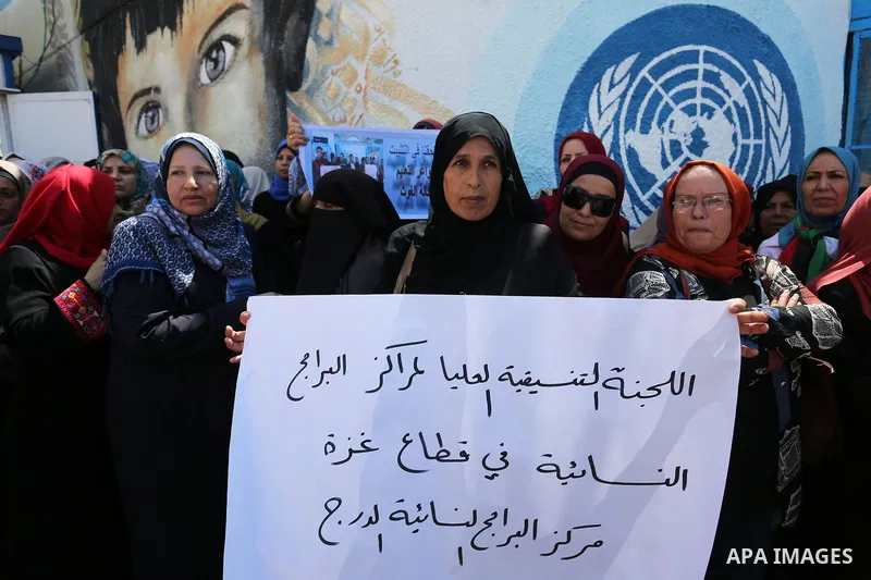 Palestinian employees of United Nations Relief and Works Agency (UNRWA) take part in a protest against job cuts announced by the agency outside its offices in Gaza City on July 29, 2018. Photo by Ashraf Amra