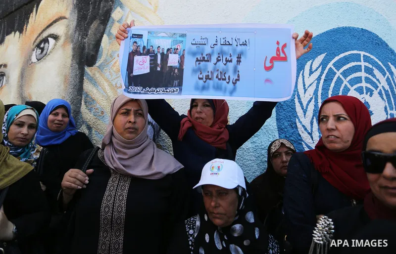 Palestinian employees of United Nations Relief and Works Agency (UNRWA) take part in a protest against job cuts announced by the agency outside its offices in Gaza City on July 29, 2018. Photo by Ashraf Amra