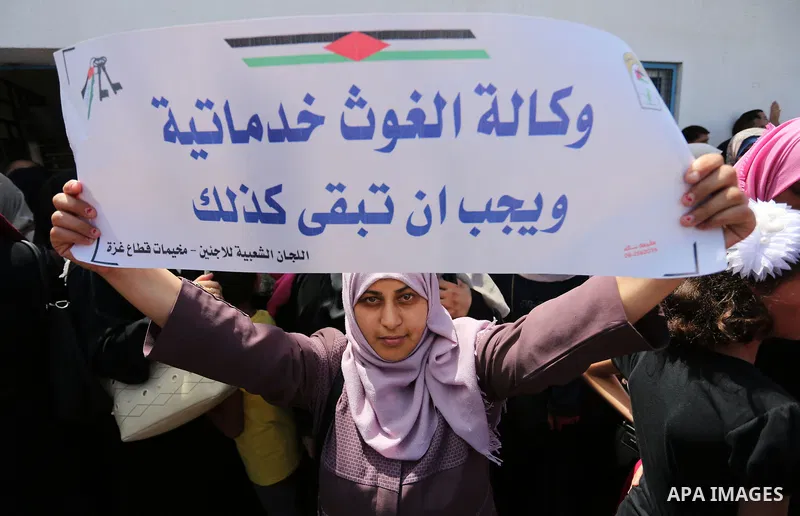 Palestinian employees of United Nations Relief and Works Agency (UNRWA) take part in a protest against job cuts announced by the agency outside its offices in Gaza City on July 29, 2018. Photo by Ashraf Amra