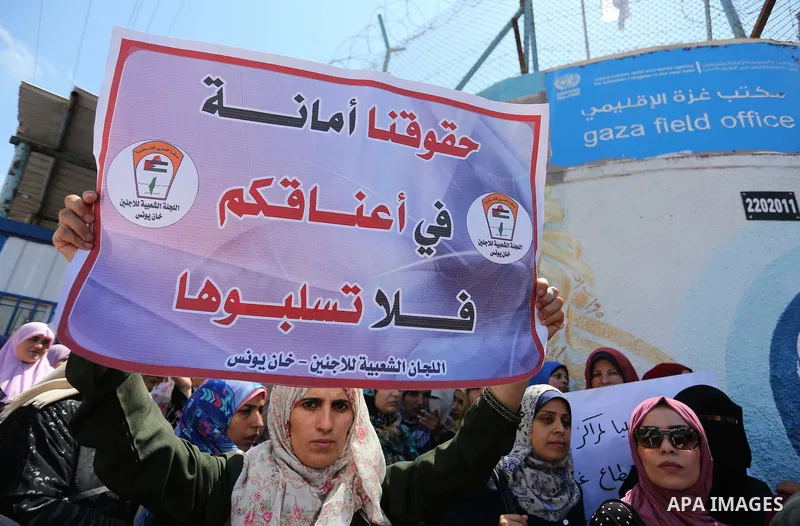 Palestinian employees of United Nations Relief and Works Agency (UNRWA) take part in a protest against job cuts announced by the agency outside its offices in Gaza City on July 29, 2018. Photo by Ashraf Amra