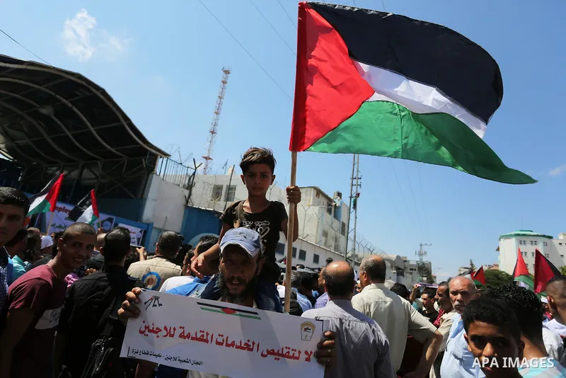 Palestinian employees of United Nations Relief and Works Agency (UNRWA) take part in a protest against job cuts announced by the agency outside its offices in Gaza City on July 29, 2018. Photo by Ashraf Amra