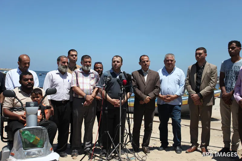 Spokesman of the National Commission to break the siege Adham Abu Salmiya, speaks during a press conference at the seaport in Gaza city on July 29, 2018. Photo by Mahmoud Ajour