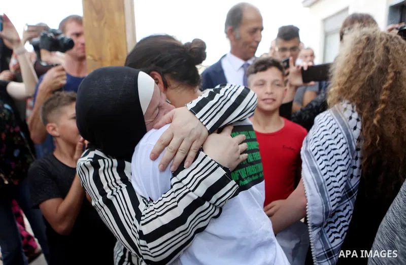 Palestinian activist and campaigner Ahed Tamimi and her mother are welcomed by friends and relatives in the West Bank village of Nabi Saleh near Ramallah on July 29, 2018, upon her release from prison after an eight-mont...