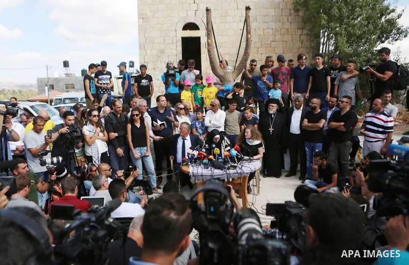 Palestinian activist and campaigner Ahed Tamimi and her mother hold a press conference in the West Bank village of Nabi Saleh near Ramallah on July 29, 2018, upon her release from prison after an eight-month sentence for...
