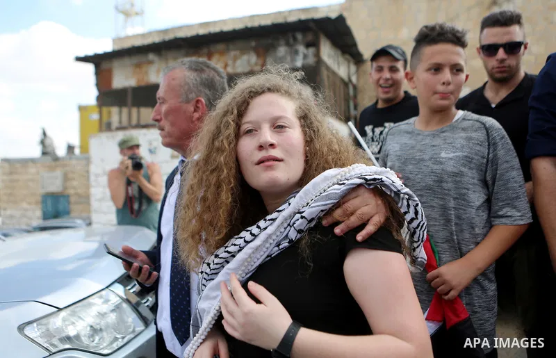 Palestinian activist and campaigner Ahed Tamimi arrives with her father before a press conference in the West Bank village of Nabi Saleh near Ramallah on July 29, 2018, upon her release from prison after an eight-month s...