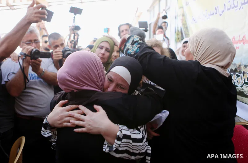 Palestinian activist and campaigner Ahed Tamimi and her mother are welcomed by friends and relatives in the West Bank village of Nabi Saleh near Ramallah on July 29, 2018, upon her release from prison after an eight-mont...