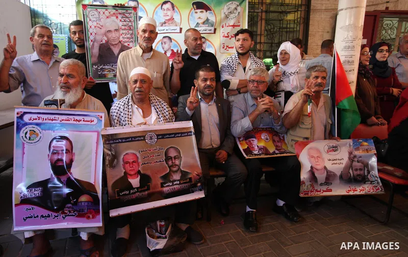 Palestinians take part in a protest to show solidarity with Palestinian prisoners held in Israeli jails, in front of Red cross office in Gaza city on July 30, 2018. Photo by Mahmoud Ajour