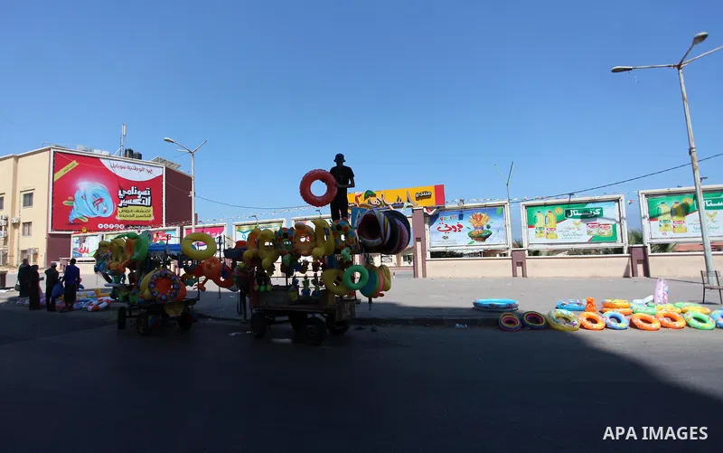 A Palestinian man displays summer games and tires at a street in Gaza city, on July 31, 2018. Photo by Mahmoud Ajour
