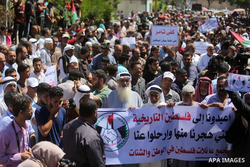 Palestinians hold banners during a demonstraion against a U.S. decision to cut aid, in front of the headquarters United Nations Relief and Works Agency (UNRWA), in Gaza City, on July 31, 2018. Photo by Ashraf Amra