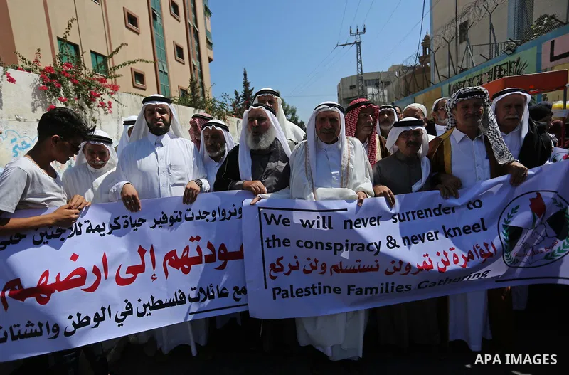 Palestinians hold banners during a demonstraion against a U.S. decision to cut aid, in front of the headquarters United Nations Relief and Works Agency (UNRWA), in Gaza City, on July 31, 2018. Photo by Ashraf Amra