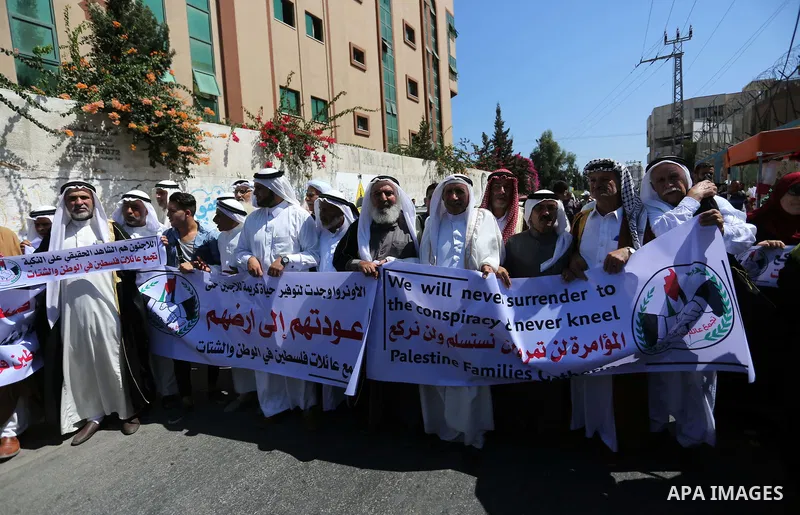 Palestinians hold banners during a demonstraion against a U.S. decision to cut aid, in front of the headquarters United Nations Relief and Works Agency (UNRWA), in Gaza City, on July 31, 2018. Photo by Ashraf Amra