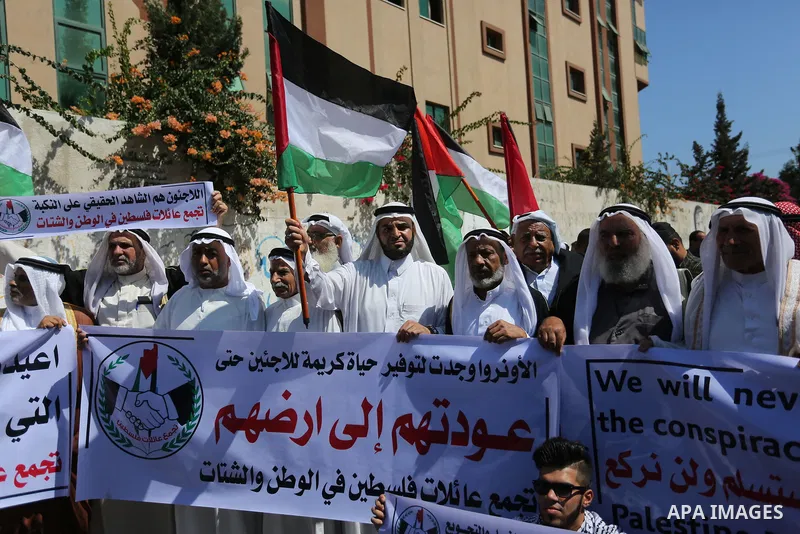 Palestinians hold banners during a demonstraion against a U.S. decision to cut aid, in front of the headquarters United Nations Relief and Works Agency (UNRWA), in Gaza City, on July 31, 2018. Photo by Ashraf Amra