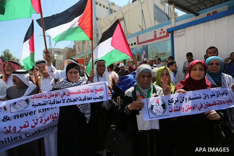 Palestinians hold banners during a demonstraion against a U.S. decision to cut aid, in front of the headquarters United Nations Relief and Works Agency (UNRWA), in Gaza City, on July 31, 2018. Photo by Ashraf Amra