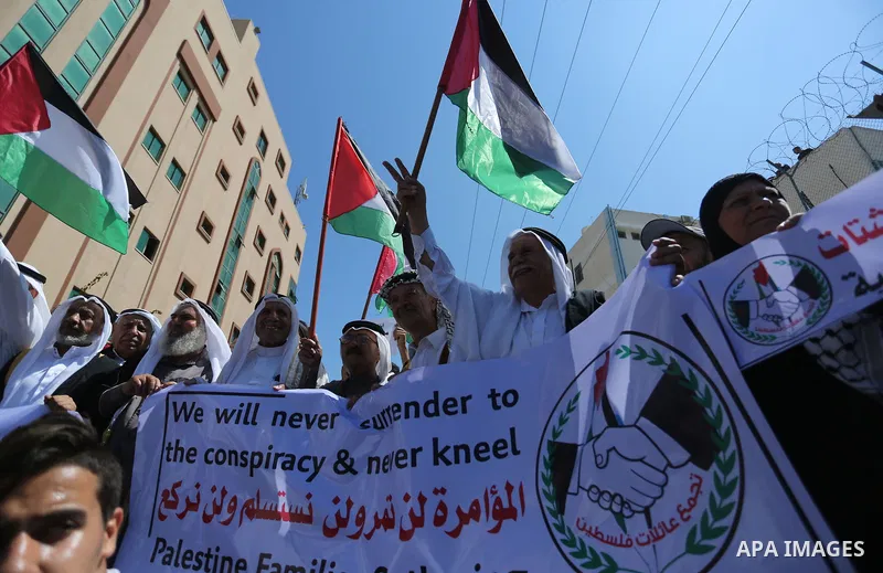 Palestinians hold banners during a demonstraion against a U.S. decision to cut aid, in front of the headquarters United Nations Relief and Works Agency (UNRWA), in Gaza City, on July 31, 2018. Photo by Ashraf Amra