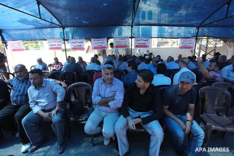Palestinians take part in a protest to show solidarity with Palestinian prisoners are paid their salaries in Iseali jails at a tent in front of the Council of Ministers headcuarter in Gaza City, on Aug. 01, 2018. Photo b...