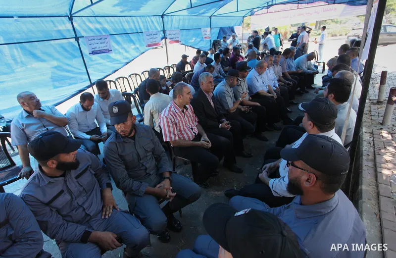 Palestinians take part in a protest to show solidarity with Palestinian prisoners are paid their salaries in Iseali jails at a tent in front of the Council of Ministers headcuarter in Gaza City, on Aug. 01, 2018. Photo b...