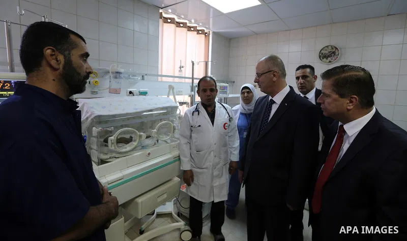 Palestinian Prime Minister Rami Hamdallah opens departments in Hebron hospitals, in the West Bank city of Hebron, on Aug. 01, 2018. Photo by Prime Minister Office