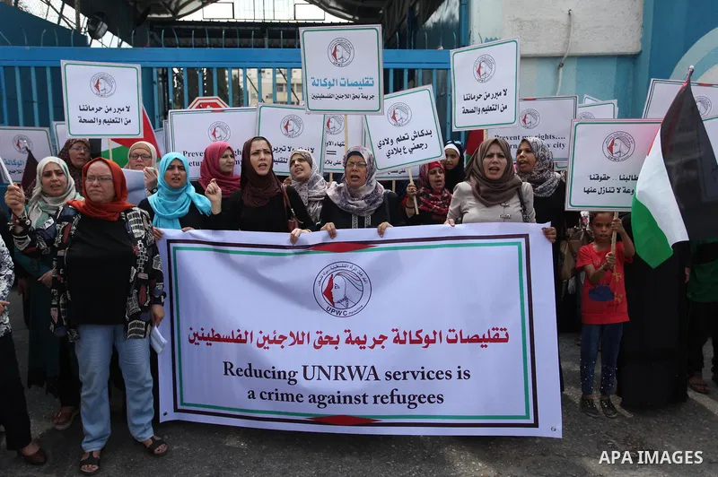 Palestinian employees of United Nations Relief and Works Agency (UNRWA) take part in a protest against a U.S. decision to cut aid, outside its offices, in Gaza City, on Aug. 02 2018. Photo by Mahmoud Ajour