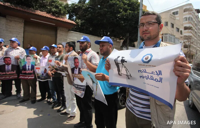 Palestinian journalists take part in a protest against the decision of the Israeli occupation to block work in Al-Quds TV in Jerusalem and West Bank, in front of the Red cross office, in Gaza city, on Aug. 02 2018. Photo...
