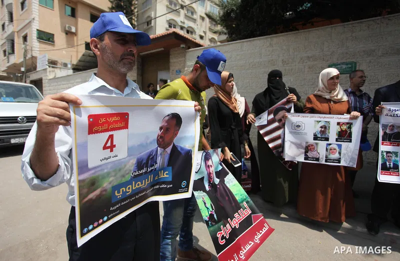 Palestinian journalists take part in a protest against the decision of the Israeli occupation to block work in Al-Quds TV in Jerusalem and West Bank, in front of the Red cross office, in Gaza city, on Aug. 02 2018. Photo...