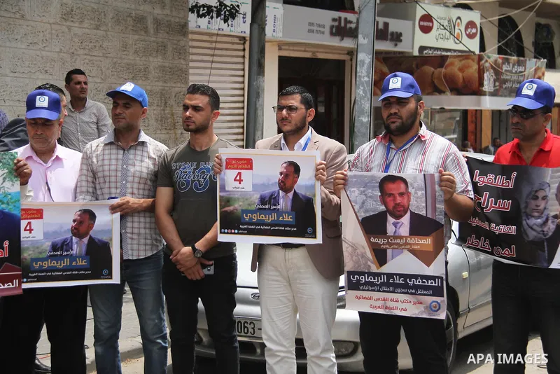 Palestinian journalists take part in a protest against the decision of the Israeli occupation to block work in Al-Quds TV in Jerusalem and West Bank, in front of the Red cross office, in Gaza city, on Aug. 02 2018. Photo...