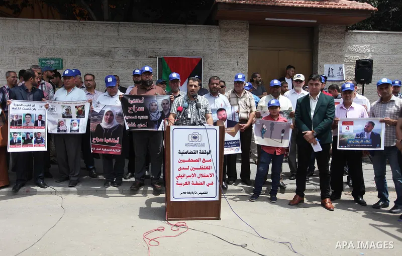 Palestinian journalists take part in a protest against the decision of the Israeli occupation to block work in Al-Quds TV in Jerusalem and West Bank, in front of the Red cross office, in Gaza city, on Aug. 02 2018. Photo...