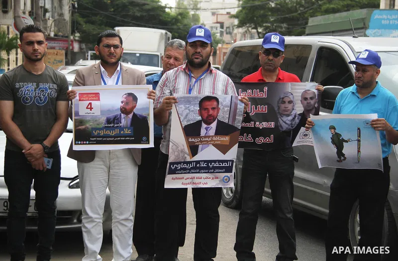 Palestinian journalists take part in a protest against the decision of the Israeli occupation to block work in Al-Quds TV in Jerusalem and West Bank, in front of the Red cross office, in Gaza city, on Aug. 02 2018. Photo...