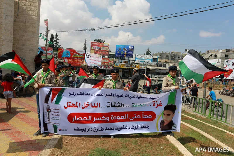 Palestinian scouts take part in a march "The Great Return March", in Rafah in the southern of Gaza strip, on Aug. 02, 2018. Photo by Abed Rahim Khatib