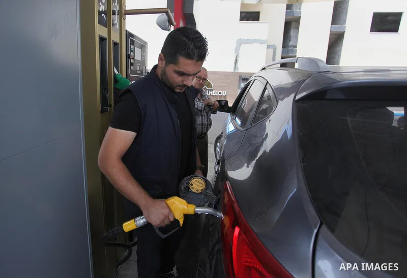 A Palestinian worker fills a car with gasoline at a gas station in Gaza city on Aug. 02, 2018. Israel reimposed a blockade of fuel supplies to Gaza on Thursday in response to a resurgence of the flow of fire kites across...